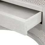 Open drawer showing white lacquered wood grain interior of side table