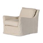 Natural linen slipcover swivel chair with sloping flared arms and loose back cushion