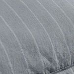 Close-up of blue linen sham texture highlighting woven pinstripe detail and natural fabric finish
