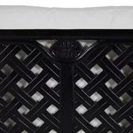 Close-up detail of sofa backrest center featuring lattice pattern and decorative floral medallion