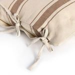 Side view focusing on three fabric bows tied along pillow edge with gold striped pattern