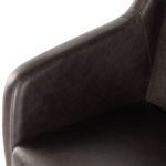 Close-up of armrest showing leather upholstery with double stitching detail