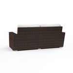 Back view showing dark cognac resin wicker weave without cushions on Montecito Loveseat