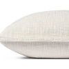 Side profile showing pillow's depth and fabric texture with ruffled trim along the edge