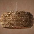 Close-up side view shows detailed texture of rattan loops on chandelier surface