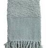 Murphy oversized throw in soft blue with bouclé texture, texture blocking pattern, and tassels at edges