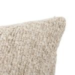 Macro shot of looped boucle yarn details on pillow corner with thick, nubby texture