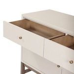 Single open drawer showing wood interior construction and antique brass knob