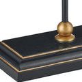 Base of lamp showing black wood grain texture around gold spherical accent