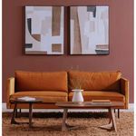 Godenza coffee table in front of burnt orange velvet sofa on thick rug with abstract wall art and two smaller tables