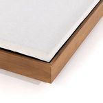 Close-up on corner of chaise showing upholstering detail and teak frame edge