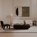 Oswin Floor Lamp in living room with white sofa, dark wood coffee table, and abstract wall art