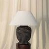 Pecola lamp on wooden stool with curtain background lit by natural daylight from side
