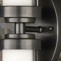 Close-up of bronze metal caps and wall mount showing brushed finish and mounting screw