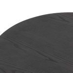 Side angle close-up highlighting rounded tapered base and edge of black ash table