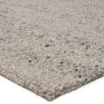 Close-up of thick wool yarn with chunky looped texture in mixed gray and brown tones