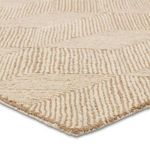 Close-up low angle showing looped tan and ivory pile and detailed texture of Castellan hand-tufted rug