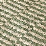 close-up showing thick jute fibers in alternating green and natural stripes with visible texture