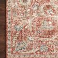 Corner of rug lying flat on hardwood floor, focusing on border detail and color variation
