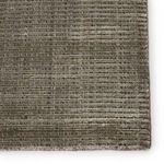 Detailed close-up of rug edge showing fine craftsmanship and alternating cut and looped rows in taupe