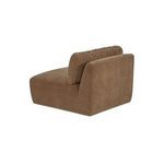 Side angle view showing chair’s rounded back cushion and smooth fabric-wrapped sides