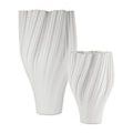 Two white porcelain vases side by side showing size difference with matching twisted ribbed patterns