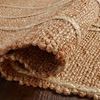 Rolled edge of Bodhi Natural Ivory Rug showing thick natural jute weave and cream braided details