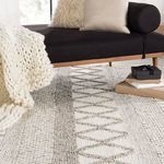Low angled shot of rug under sofa with stacked gift boxes on top