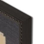 Close-up of dark wooden frame corner with carved edge detail and visible wood grain texture