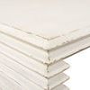 Extreme close-up focusing on layered side panel detailing with worn antique white paint