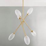 Chandelier viewed from below showing six frosted glass shades and aged brass arms against light gray wall