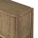 Detail of curved top corner joint where the sideboard’s wood frame meets the smoked oak panels