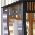 Close-up of lantern’s top section showing vertical cut-out details in black frame revealing gold leaf interior