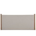 Close-up of beige textured fabric upholstery on Warren Bed headboard with wood post accents