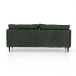 Rear view displays vertical leather panels and cushion tops against almond-finished legs