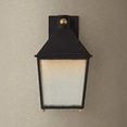 Back view of Gladden wall sconce highlighting brass wall mount ball detail on beige wall