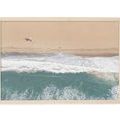 Aerial beach photography showing crashing waves on sandy shore with a lone surfboarder near the water's edge in a natural ...