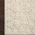 Corner of Cecelia Mist rug on dark wood floor showing detailed pattern and pile height