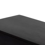 Close-up of dresser top surface with flat smooth finish in black wood