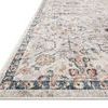 Close-up angled view showing plush pile texture and detailed navy border of rug