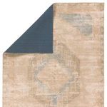 Top corner flipped to show solid blue backing contrasting the tan and blue medallion design