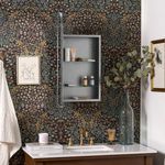 Open cabinet wall mounted with toiletries on shelves in decorative floral wallpaper bathroom