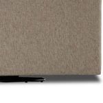 Close-up of chair lower panel and swivel base with visible fabric texture and black circular base