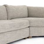 Close-up showing segmented cushions and corner joining seam on grey fabric