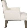 Side profile highlights the chair’s high backrest, armrest shape, and gently tapered wooden legs