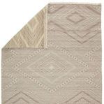Back side of the Suriya rug flipped to reveal lighter reverse pattern in similar taupe and cream hues