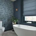 Rustic Weft Wallpaper applied on bathroom wall with adjacent floral wallpaper and freestanding bathtub.