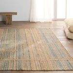 Rug with modern geometric pattern in warm natural light near window with sheer drapes