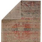 Rug corner folded over to reveal reverse side with lighter, more muted medallion pattern