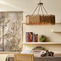Teahouse Chandelier hanging over a table in a beige room with artistic wall decor